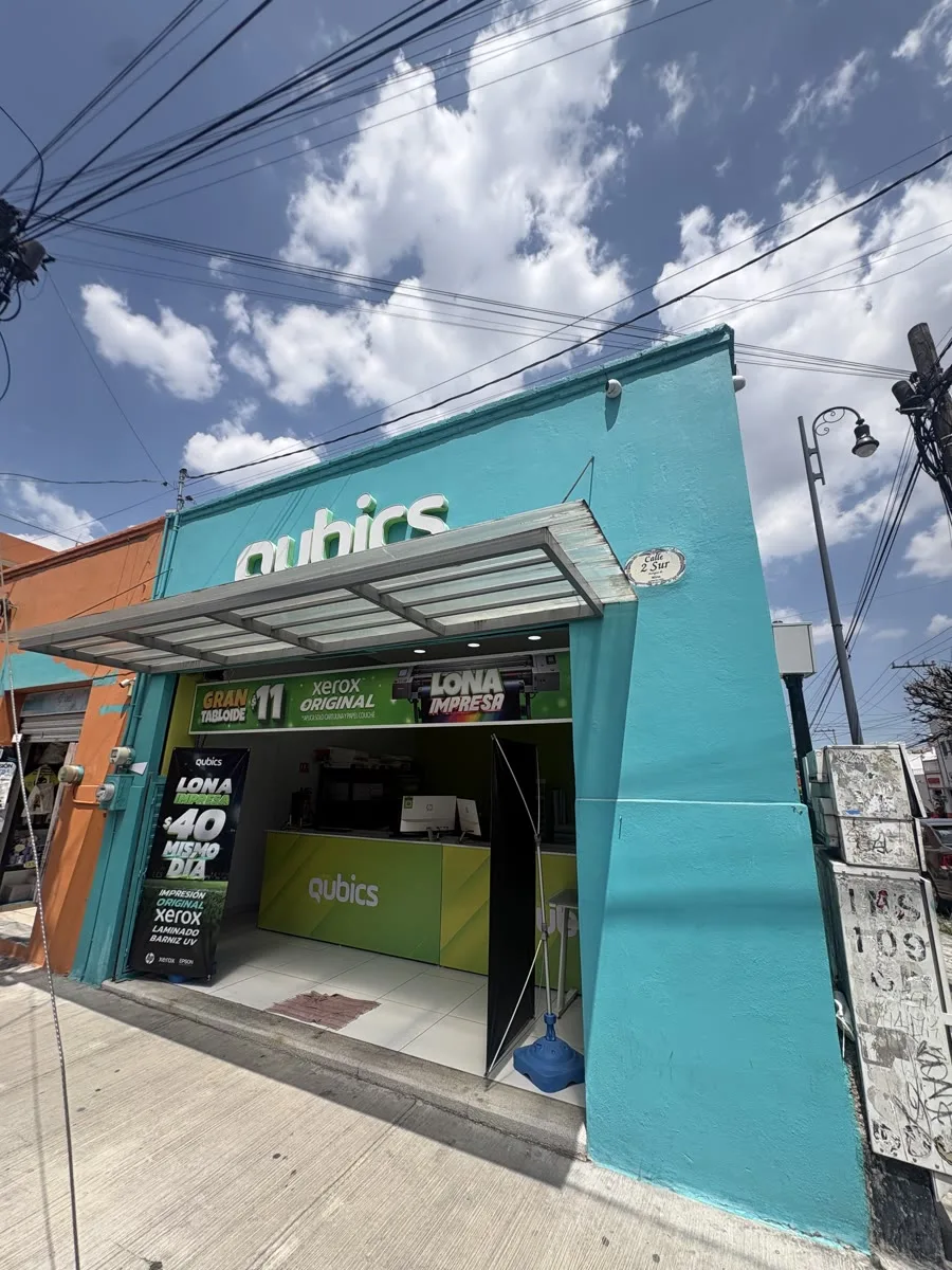 Fachada turquesa de la sucursal de 2 Sur, con sus letreros de precios